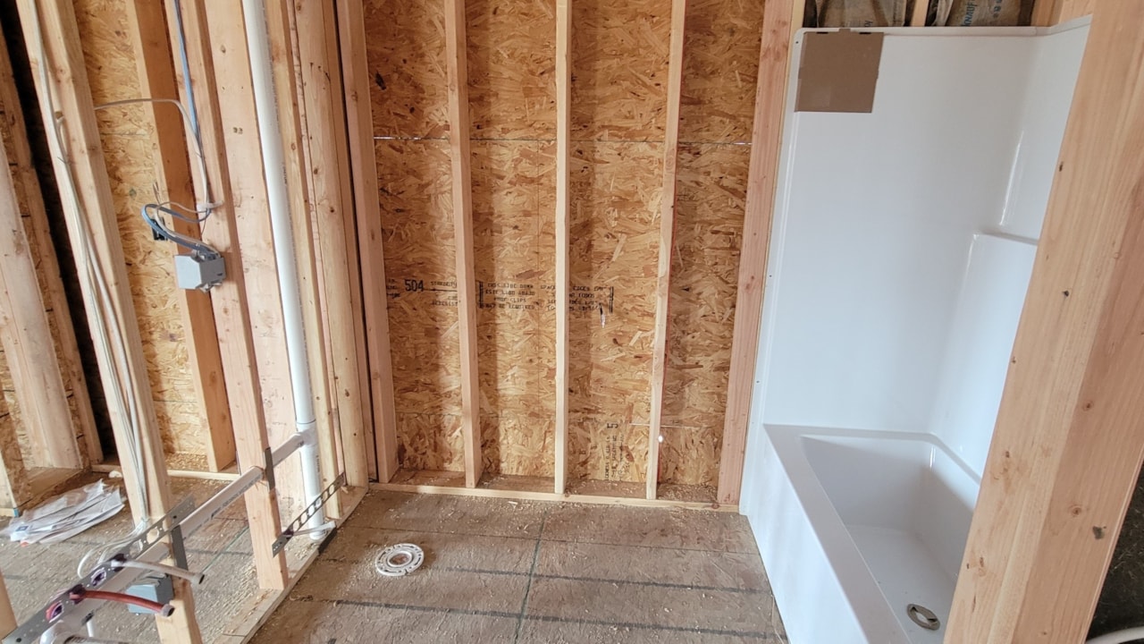 Bathroom featuring wood framing and a tub, part of Happe Homes available homes at 2912 NW Beechwood Ct, Ankeny, IA.