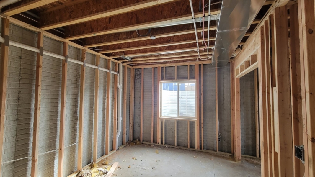 Interior view of a room featuring wood framing and drywall, showcasing Happe Homes' available properties in Ankeny, IA