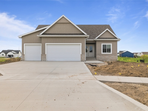 Front exterior of new construction craftsman-style home with three-car garage in Ankeny, Iowa