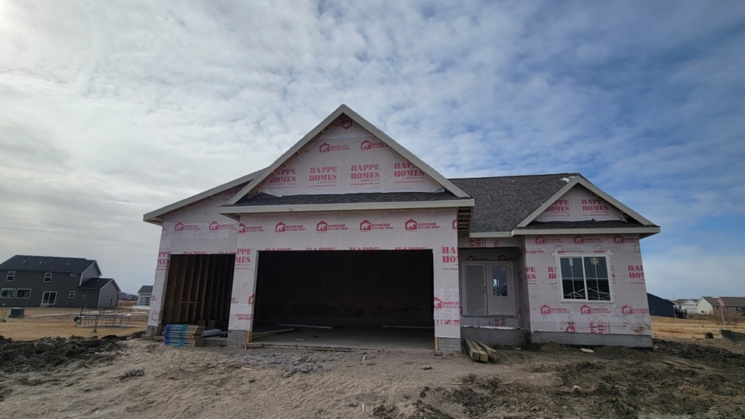 New house under construction with garage and siding, available for sale by Happe Homes at 2912 NW Beechwood Ct, Ankeny, IA.