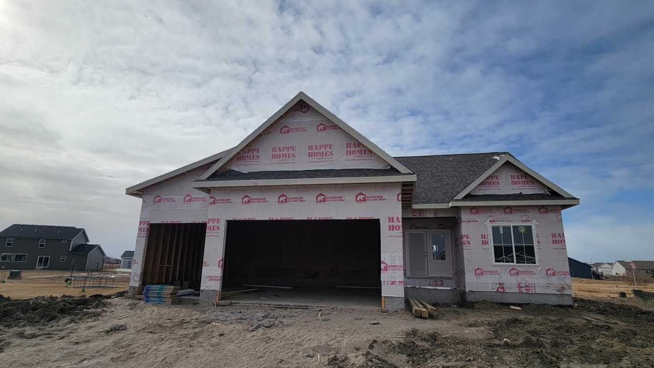 New house under construction with garage and siding, available for sale by Happe Homes at 2912 NW Beechwood Ct, Ankeny, IA.